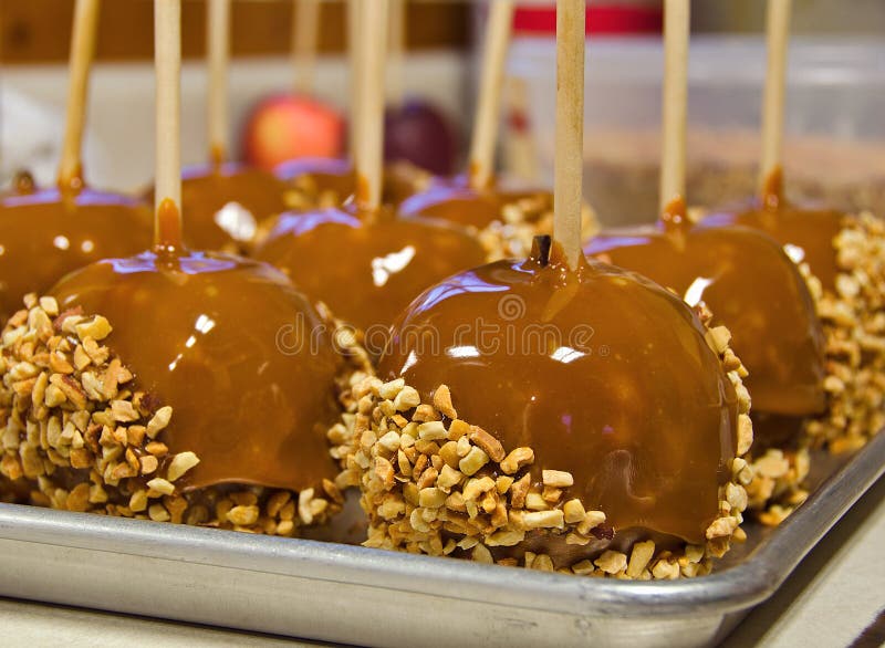 Caramel apple with nuts stock image