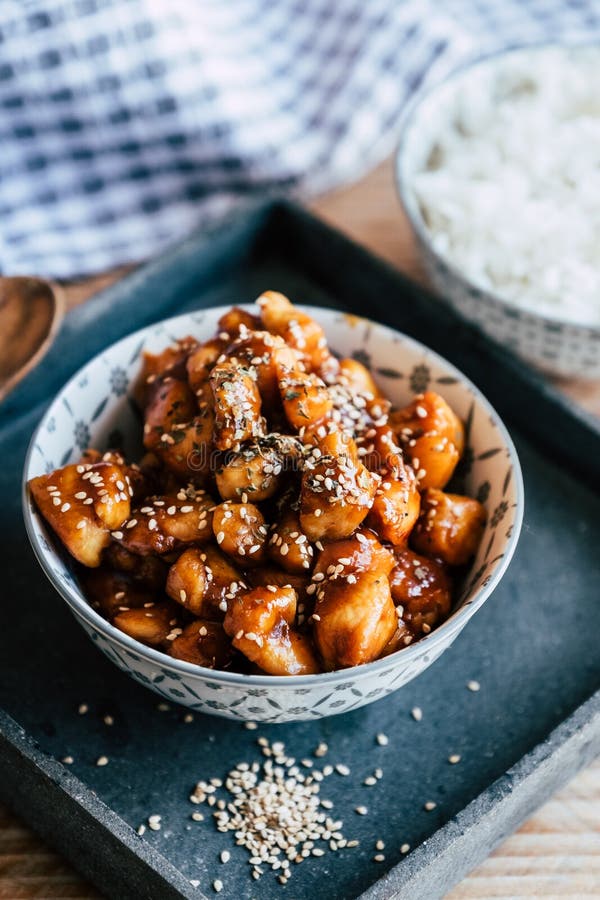 Caramelized Teriyaki Chicken with Sesame Seeds in a Bowl Stock Photo
