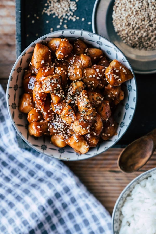 Caramelized Teriyaki Chicken with Sesame Seeds in a Bowl Stock Photo