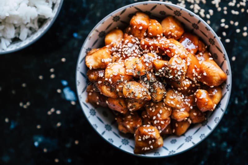 Caramelized Teriyaki Chicken with Sesame Seeds in a Bowl Stock Photo