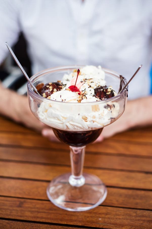 Hot fudge with chantilly and ice cream in a large glass. Hot fudge with chantilly and ice cream in a large glass