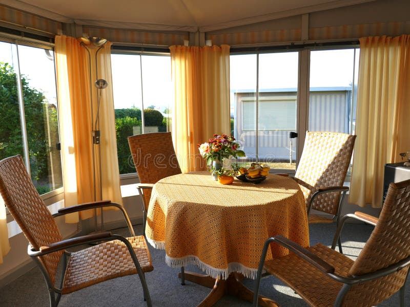 Caravan with a fixed veranda made of awning fabric, glass sliding windows and blinds on a German campsite. Comfortable and well ma stock images Caravan with a fixed veranda made of awning fabric, glass sliding windows and blinds on a German campsite. Comfortable and well ma stock images