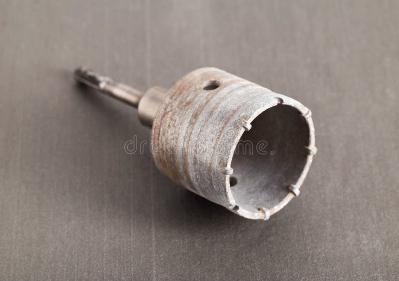 Carbide Drill Bit for Concrete with Diamond Tips. Crown for Socket Boxes in the Wall on a Gray