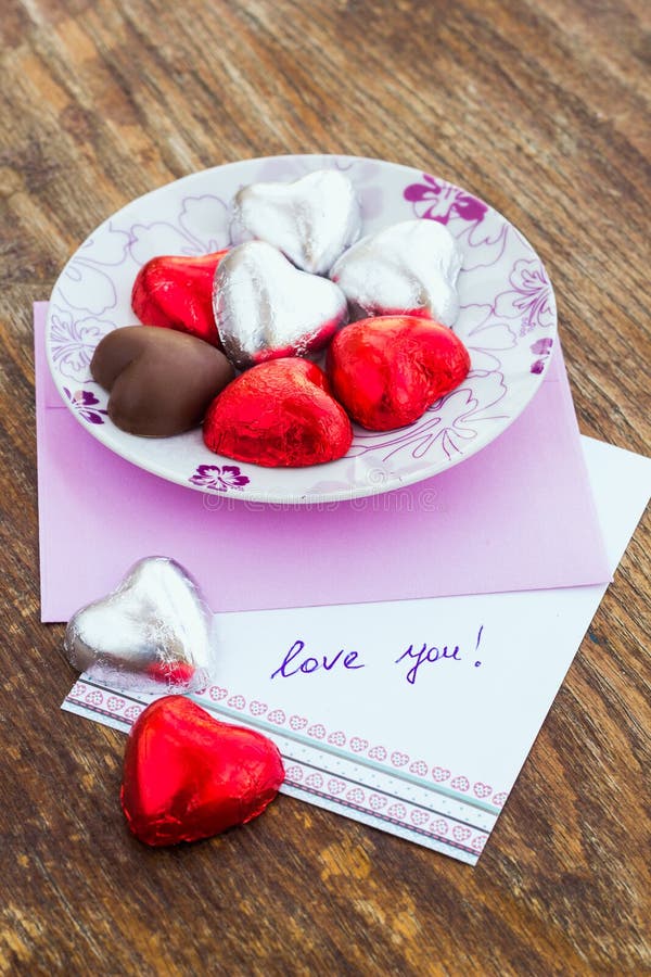 Card with Message Love You and chocolate candy