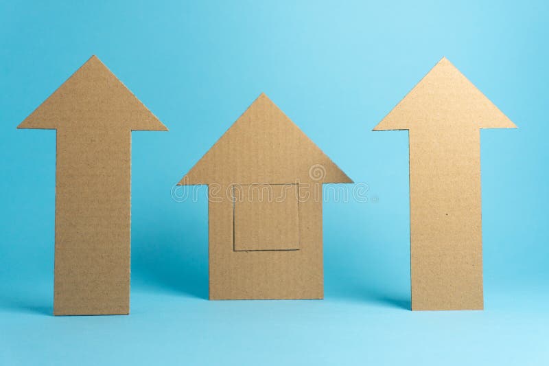 Several cardboard shapes including arrows and a house form are placed on a light blue background. The items are used for a craft project or visual display at an arts and crafts session. Cardboard color shapes stock images, royalty-free photos and pictures