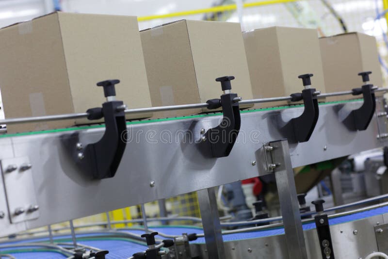 Cardboard boxes on conveyor belt in factory