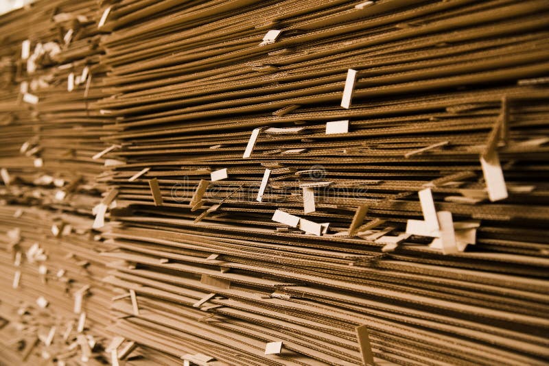 The cardboard is in the stack. The cardboard is neatly placed in a stack for further use