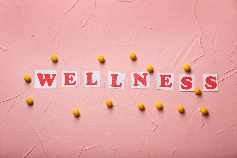 Cards with word WELLNESS and pills on color background. Health care concept stock photography Cards with word WELLNESS and pills on color background. Health care concept stock photography