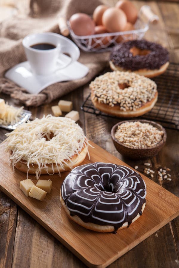 4 menu of Donut with different topping and coffee will accompany your afternoon. Rustic colour. portrait. 4 menu of Donut with different topping and coffee will accompany your afternoon. Rustic colour. portrait