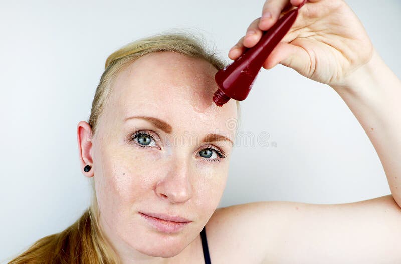 A young woman puts a gel mask on her face. Care for oily, problem skin stock images A young woman puts a gel mask on her face. Care for oily, problem skin stock images
