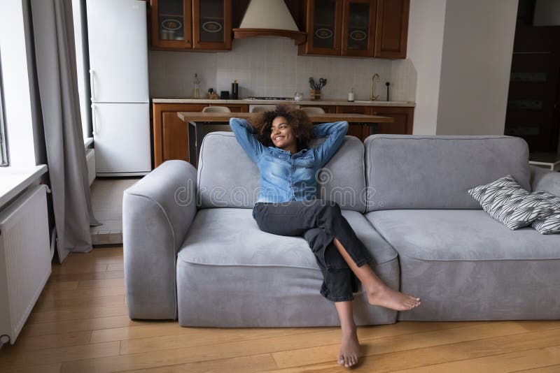 Carefree African teenager girl relaxing at home