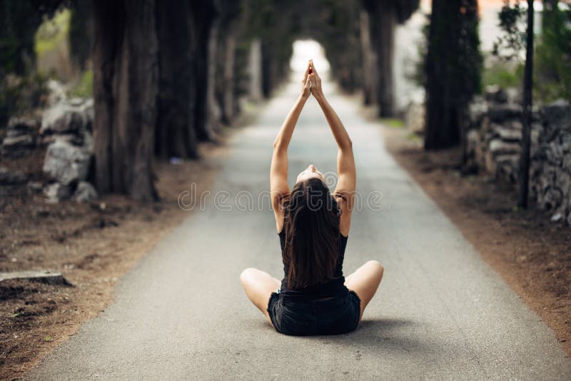 Carefree calm woman meditating in nature.Finding inner peace.Yoga practice.Spiritual healing lifestyle.Enjoying peace,anti-stress