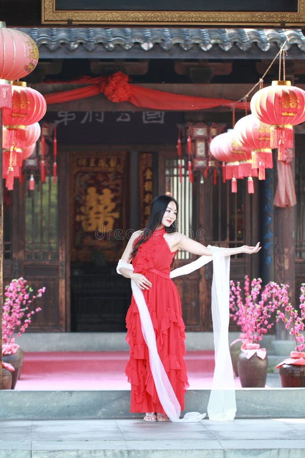 Carefree Chinese beauty is dancing in red dress stock images Carefree Chinese beauty is dancing in red dress stock images