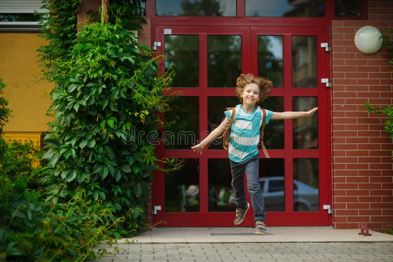 The carefree first grader rejoices to the beginning of summer vacation. royalty free stock photos