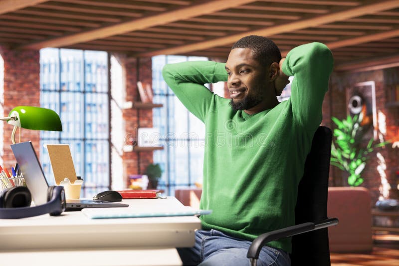 Carefree man at home relaxing, watching TV series on laptop stock images