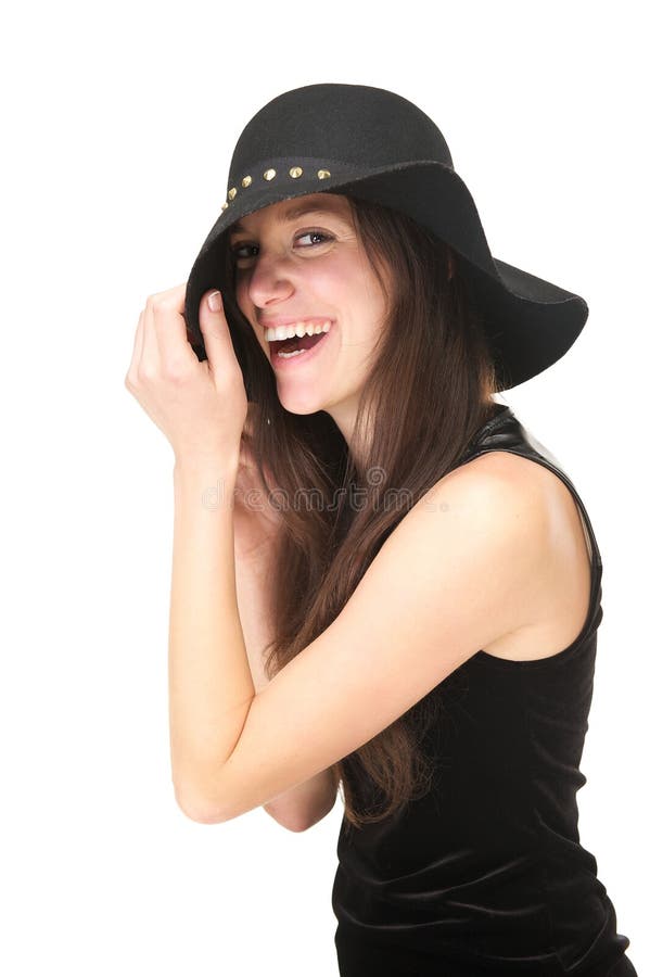 Carefree young woman laughing with black hat