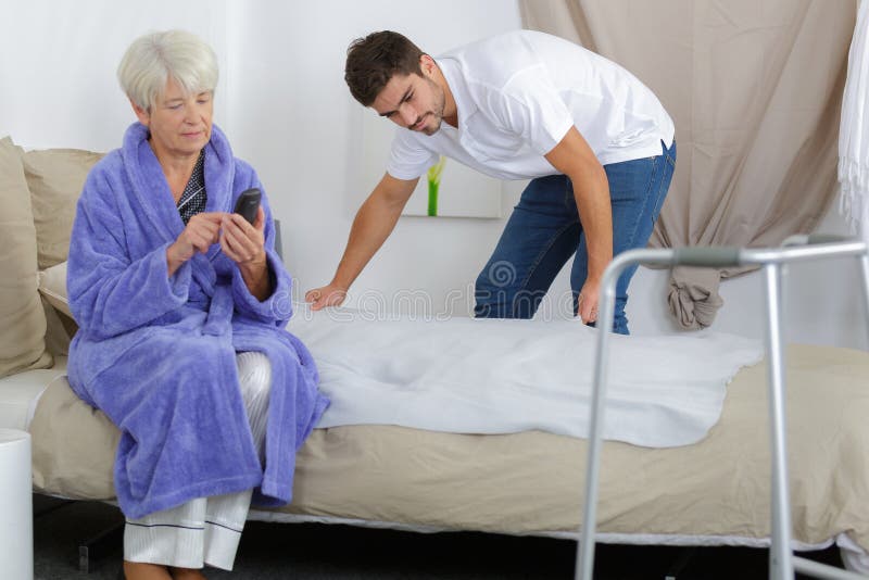 Carer Preparing Bed for Elderly Woman Stock Photo Image of female