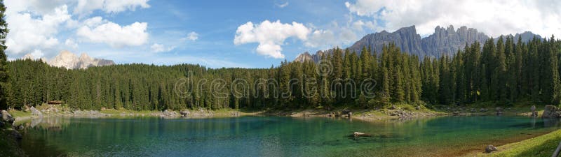 Scenic panorama of Carezza lake in the italian region of Trentino-Alto Adige (South Tyrol) and the Dolomites in the background. Scenic panorama of Carezza lake in the italian region of Trentino-Alto Adige (South Tyrol) and the Dolomites in the background.