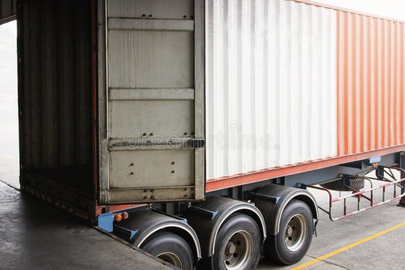 Cargo container truck loading at dock warehouse. Trailer docking stations. Industry freight truck transport. Cargo container truck loading at dock warehouse. Trailer docking stations. Industry freight truck transport