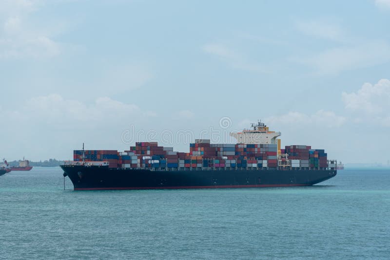 Cargo container ship anchored at road of Singapore.