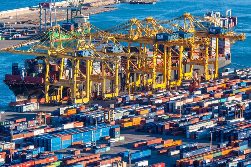 Big vessel is unloaded with cranes in cargo terminal located in Barcelona. Big vessel is unloaded with cranes in cargo terminal located in Barcelona.