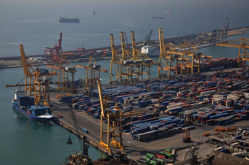 Port in Barcelona receiving cargo, useful for illustrating, shipment of cargo, working port, import, export, travel container movement, economy free trade. Port in Barcelona receiving cargo, useful for illustrating, shipment of cargo, working port, import, export, travel container movement, economy free trade