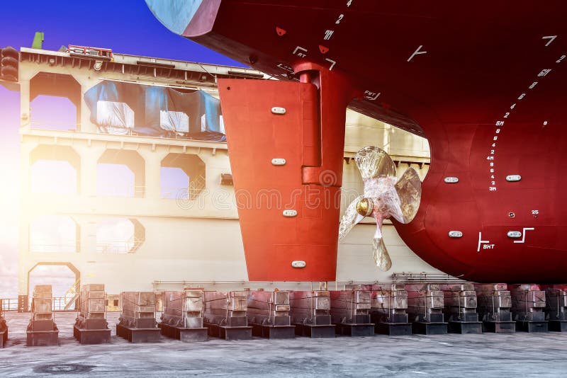 Propeller with rudder Close up and Repair Cargo ship in floating dry dock.