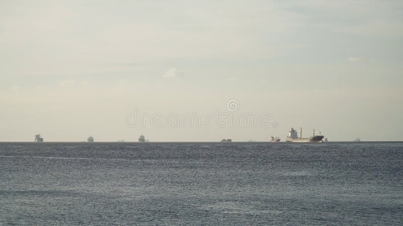 Cargo ships anchored in the sea. Philippines, Manila. royalty free stock photo Cargo ships anchored in the sea. Philippines, Manila. royalty free stock photo