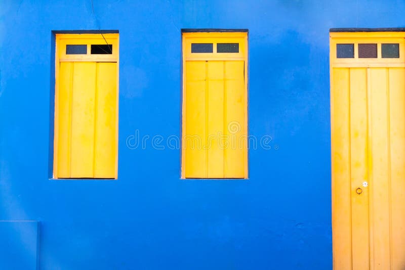 Caribbean Colorful Light Blue Facade with Bright Yellow Door and Windows