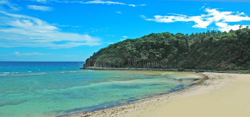 White clouds, blue sky, turquois water, palm trees, and Spanish villas in the background. The essence of a tropical paradise. White clouds, blue sky, turquois water, palm trees, and Spanish villas in the background. The essence of a tropical paradise