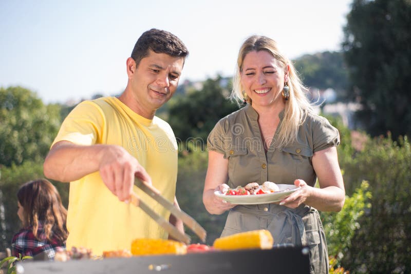 Caring Husband and Wife Making BBQ in Backyard Stock Ph