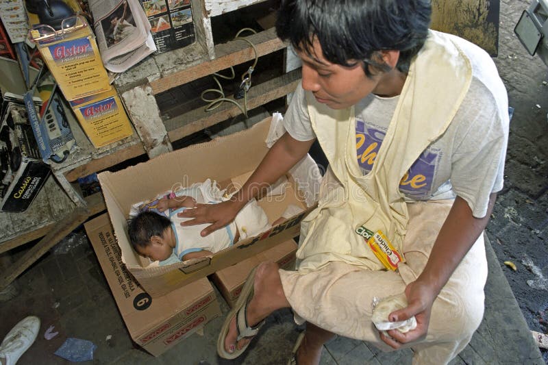 Caring latino mother in market stall, Managua