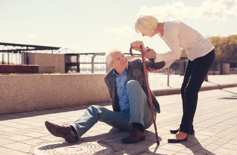 Caring senior woman helping her husband get up stock photography Caring senior woman helping her husband get up stock photography