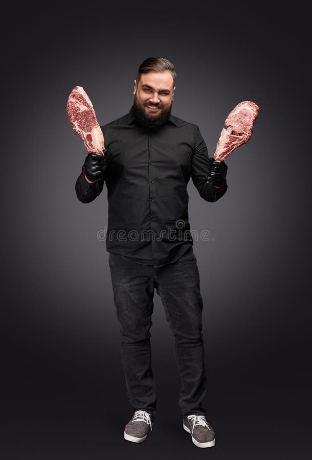 Carnicero fantasmagórico con la carne fresca imagen de archivo Carnicero fantasmagórico con la carne fresca imagen de archivo