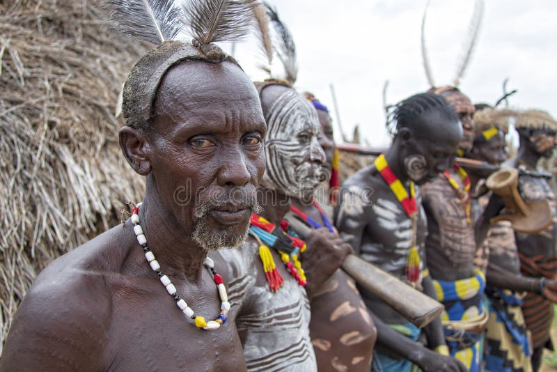 The Karo, or Kara, are a Nilotic ethnic group in Ethiopia famous for their body painting. They are also one of the smallest tribes in the region with an estimated population of 1.000-1.200 people. They are closely related to their neighbors, Hamer and Banna, with a lexical similarity of 81 They live along the east banks of the Omo River in southern Ethiopia and survive on agriculture and natural annual flooding. They have had the same culture and traditions for 500 years, like traditional dancing and painting their bodies with a mix of ash and fat or water.The Karo people differentiate themselves from many of the neighbouring tribes by excelling specifically in body and face painting. They paint themselves daily with coloured ochre, white chalk, yellow mineral rock, charcoal, and pulverized iron ore, all natural resources local to the area. The specific designs drawn on their bodies can change daily and vary in content, ranging from simple stars or lines to animal motifs, such as guinea fowl plumage, or to the most popular – a myriad of handprints covering the torso and legs. Both the Karo and the Hamar men use clay to construct elaborate hairstyles and headdresses for themselves, signifying status, beauty, and bravery.The photo is part of the album `SECOND ETHIOPIAN TRIBES EXPEDITION`. The Karo, or Kara, are a Nilotic ethnic group in Ethiopia famous for their body painting. They are also one of the smallest tribes in the region with an estimated population of 1.000-1.200 people. They are closely related to their neighbors, Hamer and Banna, with a lexical similarity of 81 They live along the east banks of the Omo River in southern Ethiopia and survive on agriculture and natural annual flooding. They have had the same culture and traditions for 500 years, like traditional dancing and painting their bodies with a mix of ash and fat or water.The Karo people differentiate themselves from many of the neighbouring tribes by excelling specifically in body and face painting. They paint themselves daily with coloured ochre, white chalk, yellow mineral rock, charcoal, and pulverized iron ore, all natural resources local to the area. The specific designs drawn on their bodies can change daily and vary in content, ranging from simple stars or lines to animal motifs, such as guinea fowl plumage, or to the most popular – a myriad of handprints covering the torso and legs. Both the Karo and the Hamar men use clay to construct elaborate hairstyles and headdresses for themselves, signifying status, beauty, and bravery.The photo is part of the album `SECOND ETHIOPIAN TRIBES EXPEDITION`