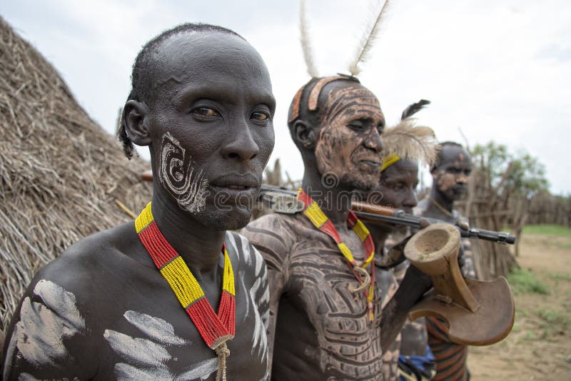 The Karo, or Kara, are a Nilotic ethnic group in Ethiopia famous for their body painting. They are also one of the smallest tribes in the region with an estimated population of 1.000-1.200 people. They are closely related to their neighbors, Hamer and Banna, with a lexical similarity of 81 They live along the east banks of the Omo River in southern Ethiopia and survive on agriculture and natural annual flooding. They have had the same culture and traditions for 500 years, like traditional dancing and painting their bodies with a mix of ash and fat or water.The Karo people differentiate themselves from many of the neighbouring tribes by excelling specifically in body and face painting. They paint themselves daily with coloured ochre, white chalk, yellow mineral rock, charcoal, and pulverized iron ore, all natural resources local to the area. The specific designs drawn on their bodies can change daily and vary in content, ranging from simple stars or lines to animal motifs, such as guinea fowl plumage, or to the most popular – a myriad of handprints covering the torso and legs. Both the Karo and the Hamar men use clay to construct elaborate hairstyles and headdresses for themselves, signifying status, beauty, and bravery.The photo is part of the album `SECOND ETHIOPIAN TRIBES EXPEDITION`. The Karo, or Kara, are a Nilotic ethnic group in Ethiopia famous for their body painting. They are also one of the smallest tribes in the region with an estimated population of 1.000-1.200 people. They are closely related to their neighbors, Hamer and Banna, with a lexical similarity of 81 They live along the east banks of the Omo River in southern Ethiopia and survive on agriculture and natural annual flooding. They have had the same culture and traditions for 500 years, like traditional dancing and painting their bodies with a mix of ash and fat or water.The Karo people differentiate themselves from many of the neighbouring tribes by excelling specifically in body and face painting. They paint themselves daily with coloured ochre, white chalk, yellow mineral rock, charcoal, and pulverized iron ore, all natural resources local to the area. The specific designs drawn on their bodies can change daily and vary in content, ranging from simple stars or lines to animal motifs, such as guinea fowl plumage, or to the most popular – a myriad of handprints covering the torso and legs. Both the Karo and the Hamar men use clay to construct elaborate hairstyles and headdresses for themselves, signifying status, beauty, and bravery.The photo is part of the album `SECOND ETHIOPIAN TRIBES EXPEDITION`