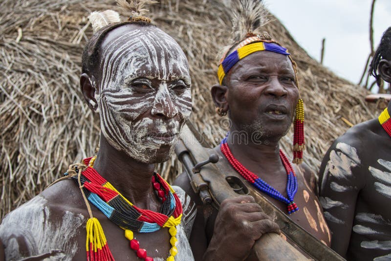 The Karo, or Kara, are a Nilotic ethnic group in Ethiopia famous for their body painting. They are also one of the smallest tribes in the region with an estimated population of 1.000-1.200 people. They are closely related to their neighbors, Hamer and Banna, with a lexical similarity of 81 They live along the east banks of the Omo River in southern Ethiopia and survive on agriculture and natural annual flooding. They have had the same culture and traditions for 500 years, like traditional dancing and painting their bodies with a mix of ash and fat or water.The Karo people differentiate themselves from many of the neighbouring tribes by excelling specifically in body and face painting. They paint themselves daily with coloured ochre, white chalk, yellow mineral rock, charcoal, and pulverized iron ore, all natural resources local to the area. The specific designs drawn on their bodies can change daily and vary in content, ranging from simple stars or lines to animal motifs, such as guinea fowl plumage, or to the most popular – a myriad of handprints covering the torso and legs. Both the Karo and the Hamar men use clay to construct elaborate hairstyles and headdresses for themselves, signifying status, beauty, and bravery.The photo is part of the album `SECOND ETHIOPIAN TRIBES EXPEDITION`. The Karo, or Kara, are a Nilotic ethnic group in Ethiopia famous for their body painting. They are also one of the smallest tribes in the region with an estimated population of 1.000-1.200 people. They are closely related to their neighbors, Hamer and Banna, with a lexical similarity of 81 They live along the east banks of the Omo River in southern Ethiopia and survive on agriculture and natural annual flooding. They have had the same culture and traditions for 500 years, like traditional dancing and painting their bodies with a mix of ash and fat or water.The Karo people differentiate themselves from many of the neighbouring tribes by excelling specifically in body and face painting. They paint themselves daily with coloured ochre, white chalk, yellow mineral rock, charcoal, and pulverized iron ore, all natural resources local to the area. The specific designs drawn on their bodies can change daily and vary in content, ranging from simple stars or lines to animal motifs, such as guinea fowl plumage, or to the most popular – a myriad of handprints covering the torso and legs. Both the Karo and the Hamar men use clay to construct elaborate hairstyles and headdresses for themselves, signifying status, beauty, and bravery.The photo is part of the album `SECOND ETHIOPIAN TRIBES EXPEDITION`