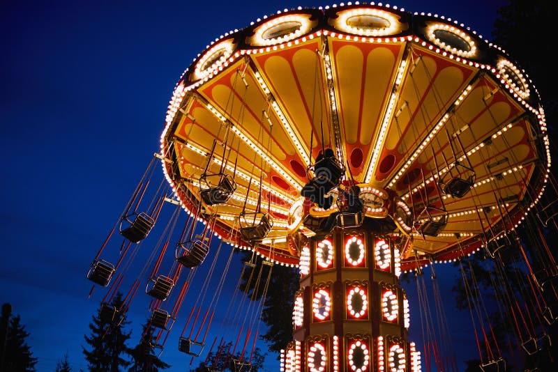 Carousel Merry-go-round in amusement park at a night city