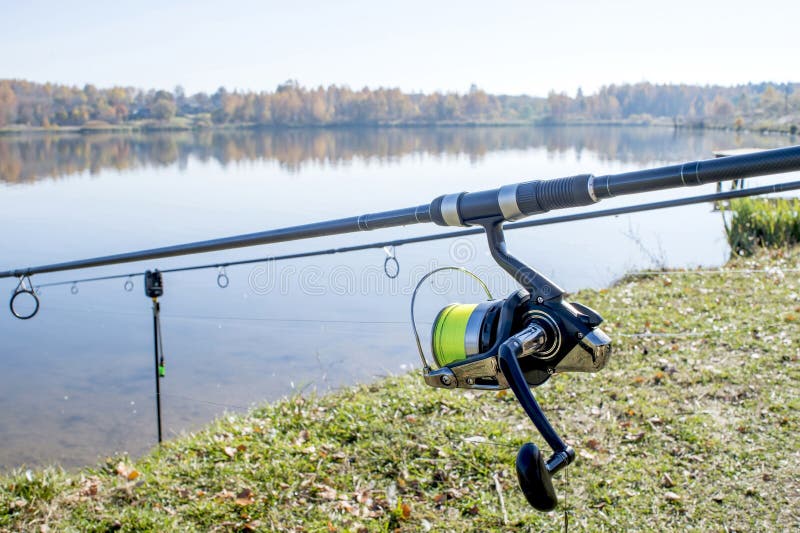 https://thumbs.dreamstime.com/b/carp-rods-installed-stands-shore-against-flat-surface-lake-coil-foreground-background-133918197.jpg