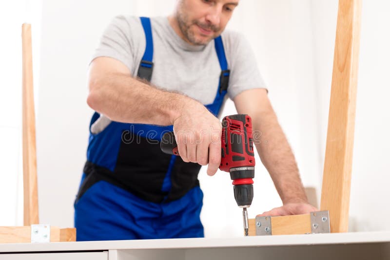 Carpenter Making Table Using Drill Working Indoor In Studio, Cropped royalty free stock image