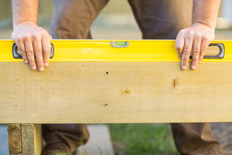 Carpenter s Hands Using Spirit Level On Wood