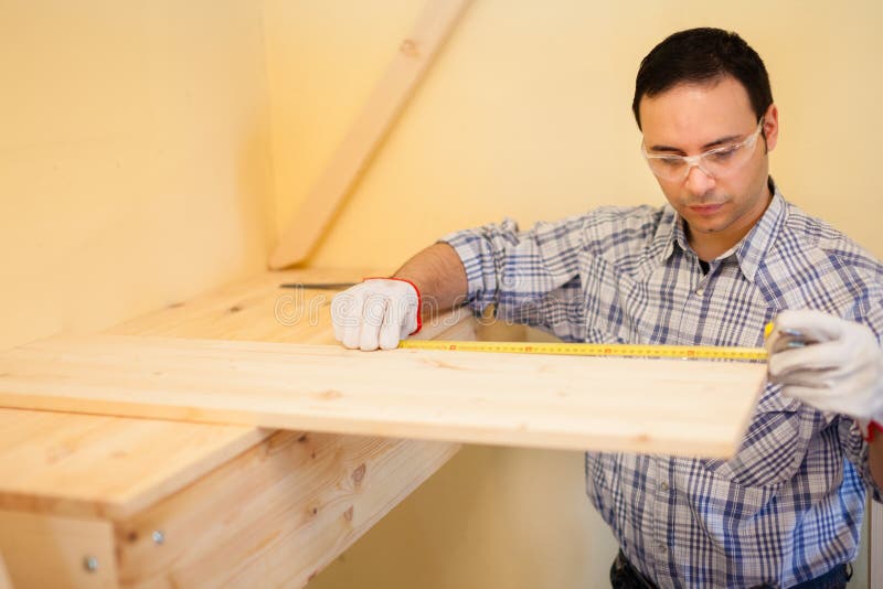 Carpenter at Work Using a Measuring Tape Stock Photo Image of safety