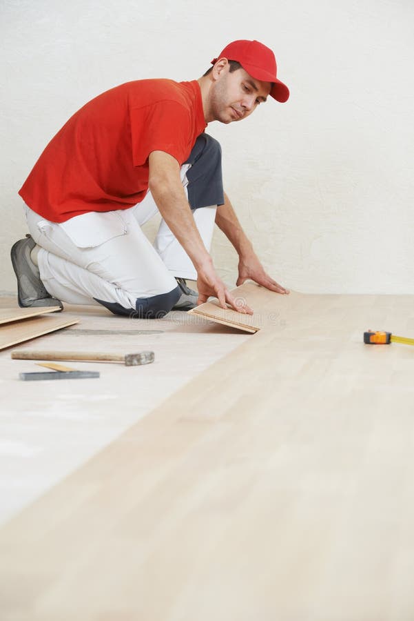 Carpenter worker joining parket floor stock photo
