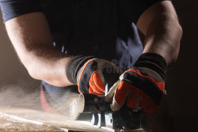 Carpenter working with electric planer royalty free stock photography