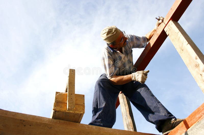Carpenter working with nails and a box of tools stock images