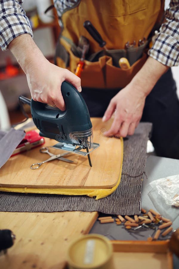 Carpenter Working on a Hand Saw Cutting Boards in His Stock