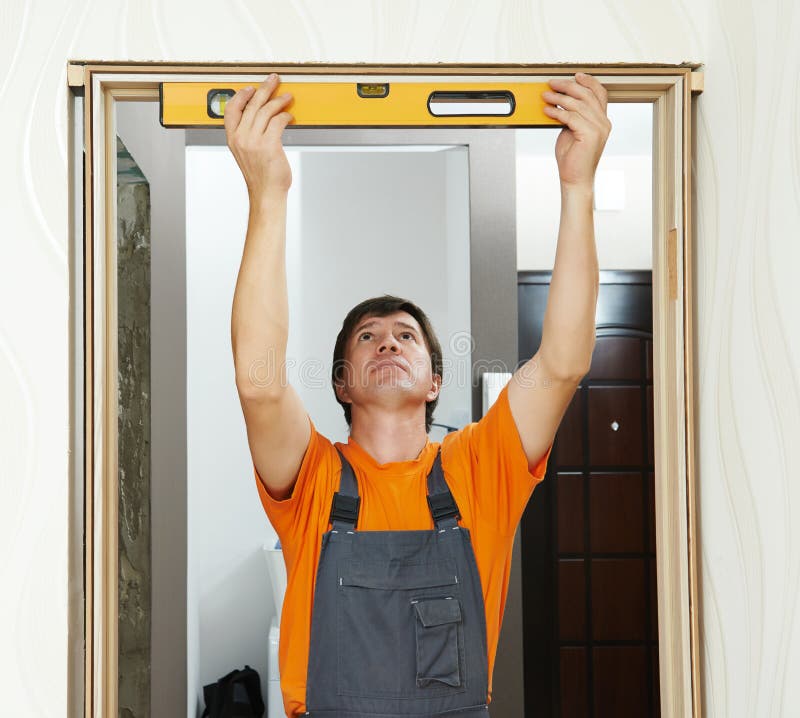 Carpenter works with level stock photo. Image of contractor 50607900