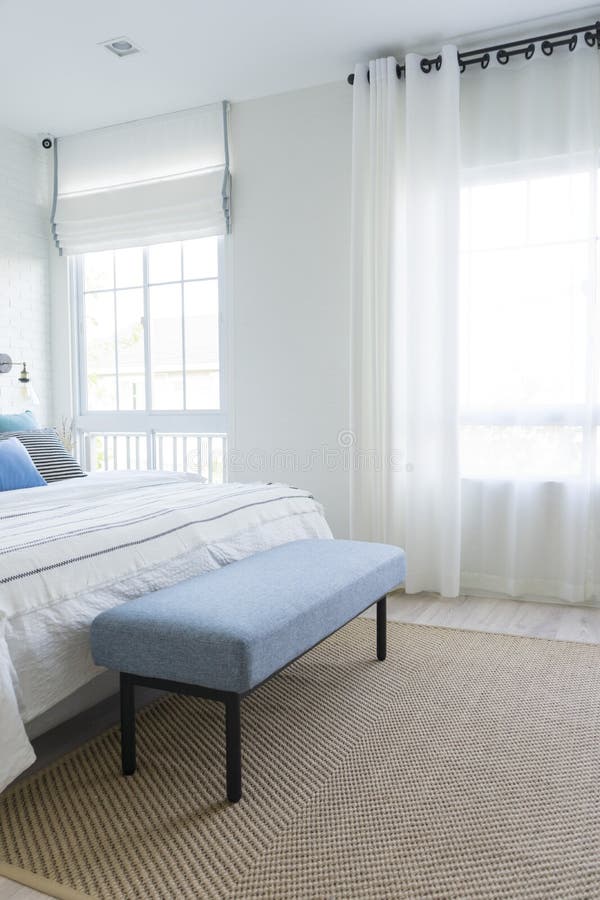 Carpet and Blue Bench Near Bed by the Window. Stock Photo Image of