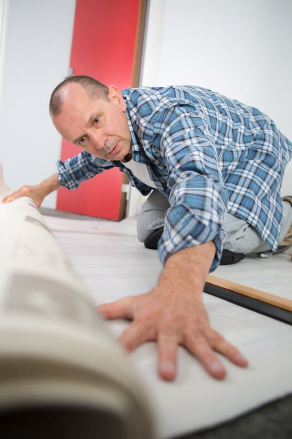 Carpet fitter at work stock photo. Image of construction 118895564