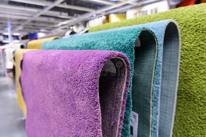 Carpets Hanging on the Shelves in the Carpet Store. Different Carpets